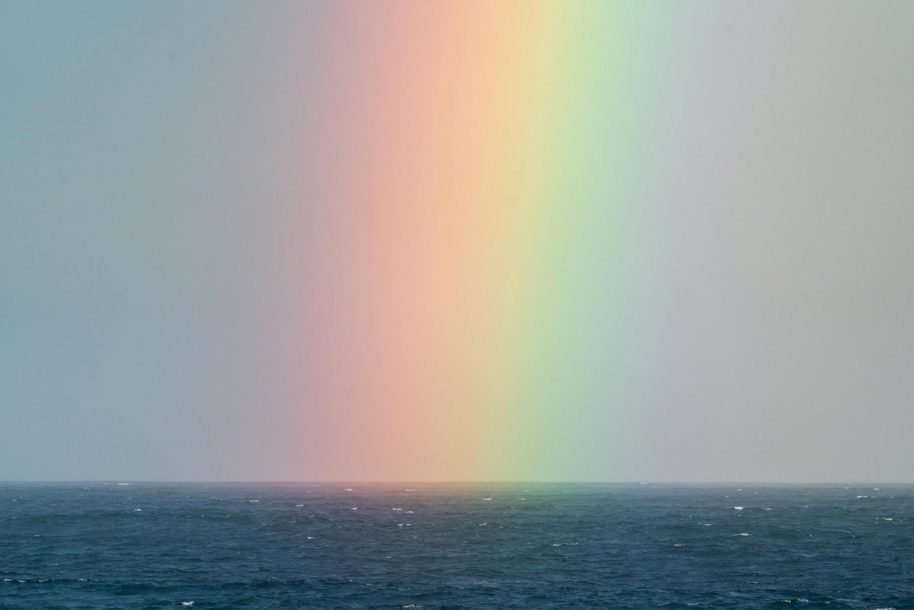 rainbow on sky over sea