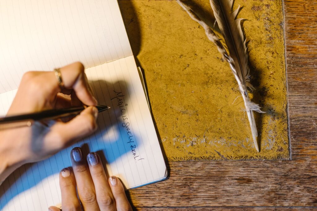 a hand writing on a notebook